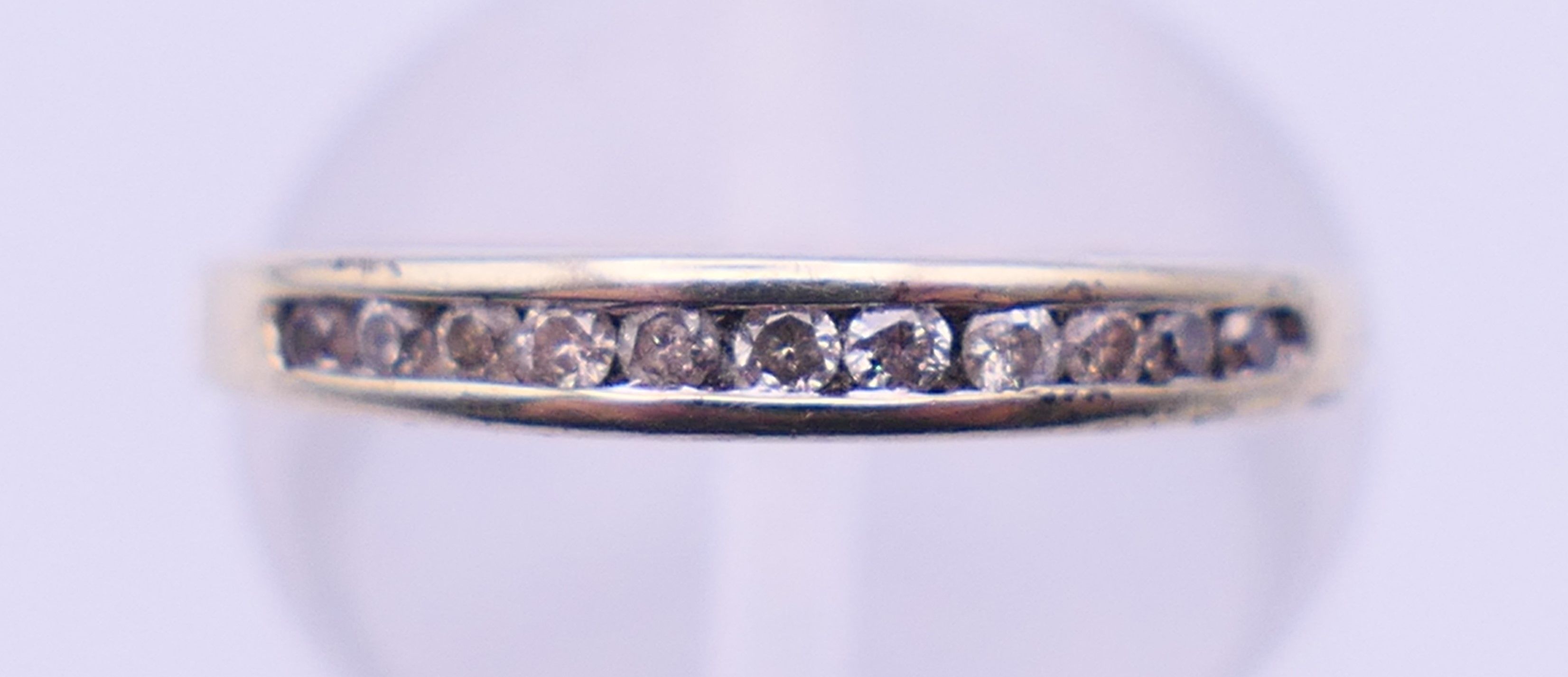 A 9 ct gold three-stone ring and an unmarked half hoop eternity ring. The former, Ring size M and 3. - Image 2 of 11