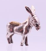 A silver pincushion in the form of a donkey, hallmarked for Birmingham 1902. 5 cm high.