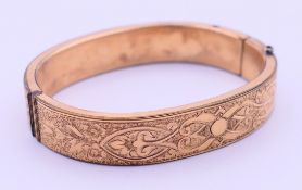 A Victorian chased bangle. 6 cm wide.