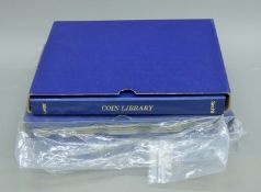 Three vacant Sandhill coin albums. Each 21 cm wide.