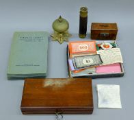 A quantity of miscellaneous items, including a desk bell, Monopoly, opera glasses and a telescope.