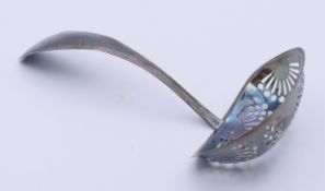 A silver sifter spoon. 15 cm long.