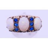 A 9 ct gold, opal and sapphire ring. Ring size Q. 4.8 grammes total weight.