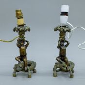 A pair of bronze table lamps, each formed as a crocodile surmounted with a cherub. Each 30 cm high.
