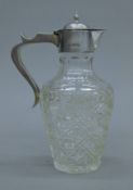 A small silver-topped cut glass claret jug. 18 cm high.