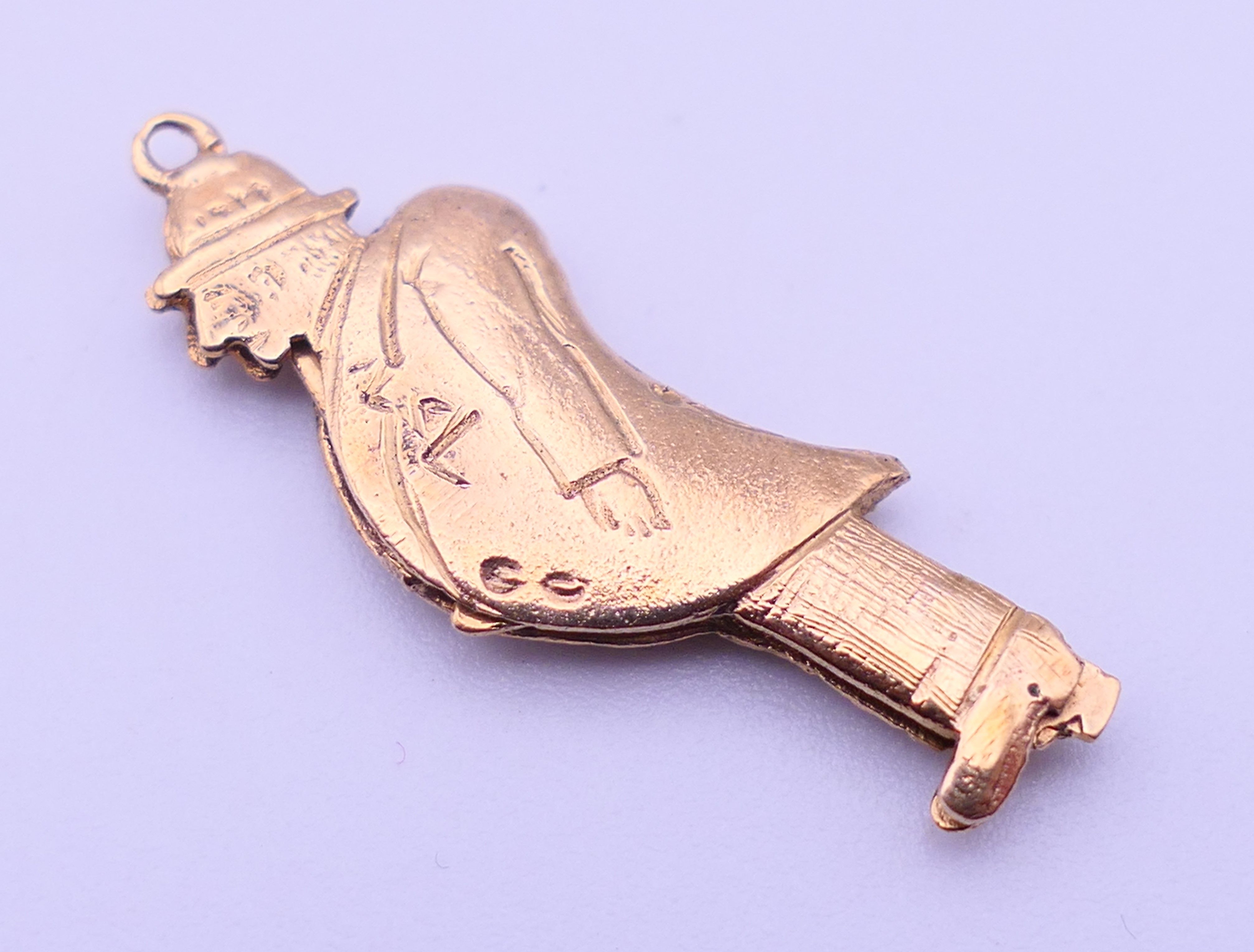 A 9ct gold charm/pendant formed as a flashing man. 3 cm high. 2.4 grammes total weight. - Image 3 of 3