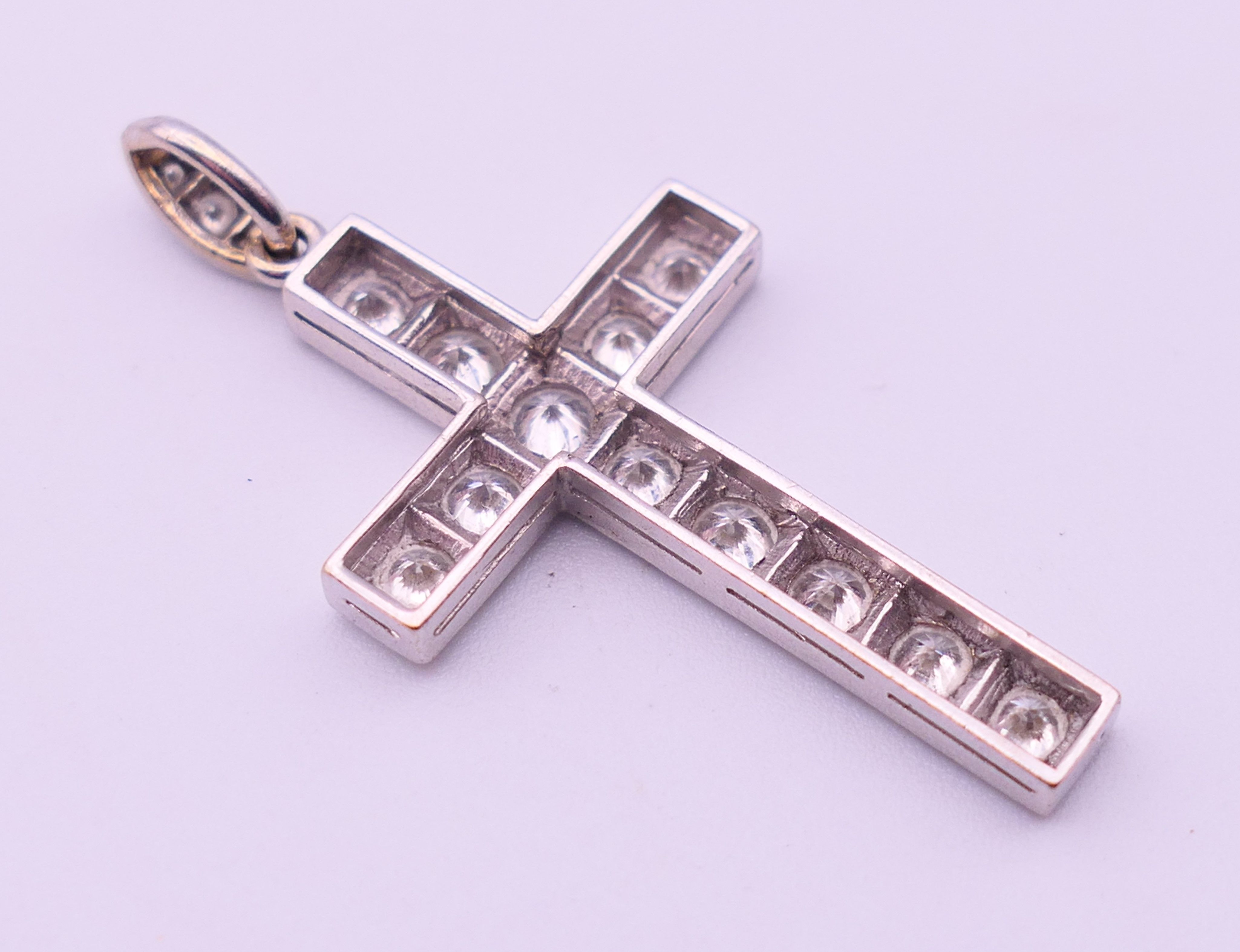 An unmarked white gold or platinum diamond set cross pendant. 4 cm high including suspension loop. - Image 2 of 3