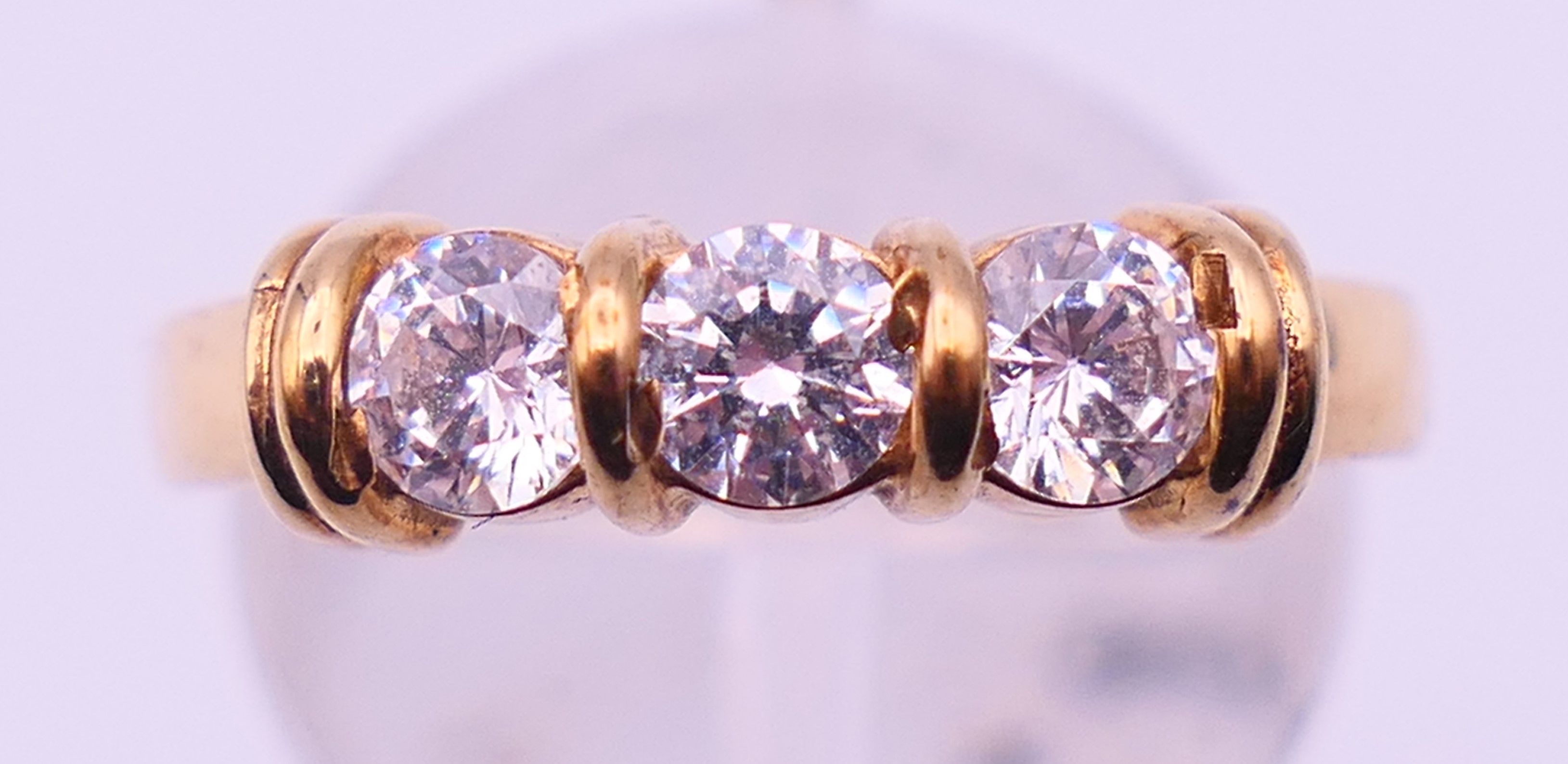 A 9 ct gold three-stone ring and an unmarked half hoop eternity ring. The former, Ring size M and 3. - Image 7 of 11