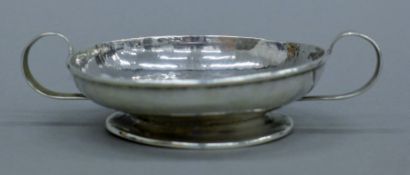 A small silver twin-handled footed dish. 11.5 cm wide. 63.7 grammes.