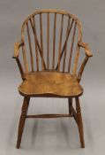 A 19th century elm-seated Windsor chair. 54 cm wide.