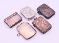 Four silver vesta cases and a silver book-form snuff box. The later 4 cm high.