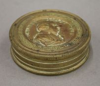 A brass snuff box, the lid decorated with a bust of Charles James Fox. 7.75 cm diameter.
