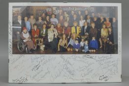 A signed photograph of the Coronation Street cast. 42 x 30 cm.