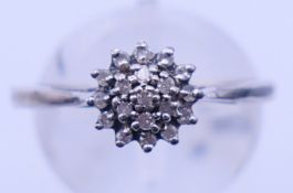 A boxed Queen Elizabeth II Diamond Jubilee silver and diamond cluster ring. Ring size P.