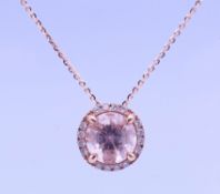 A Pravins 18 ct gold diamond and morganite halo pendant on an 18 ct gold chain,