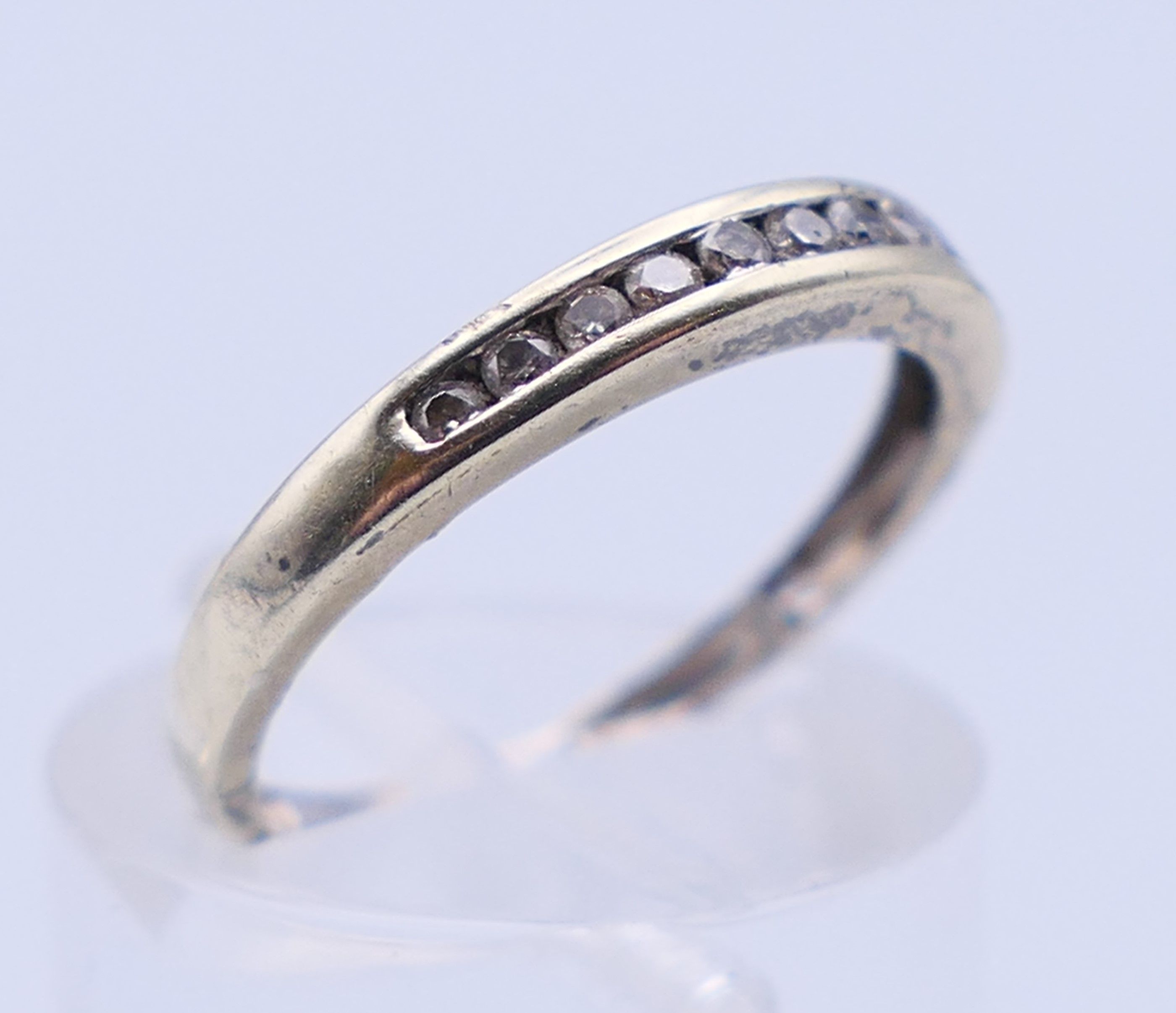 A 9 ct gold three-stone ring and an unmarked half hoop eternity ring. The former, Ring size M and 3. - Image 4 of 11