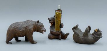 Three Black Forest carved wooden bears, one mounted as a sewing compendium. The latter 20 cm high.