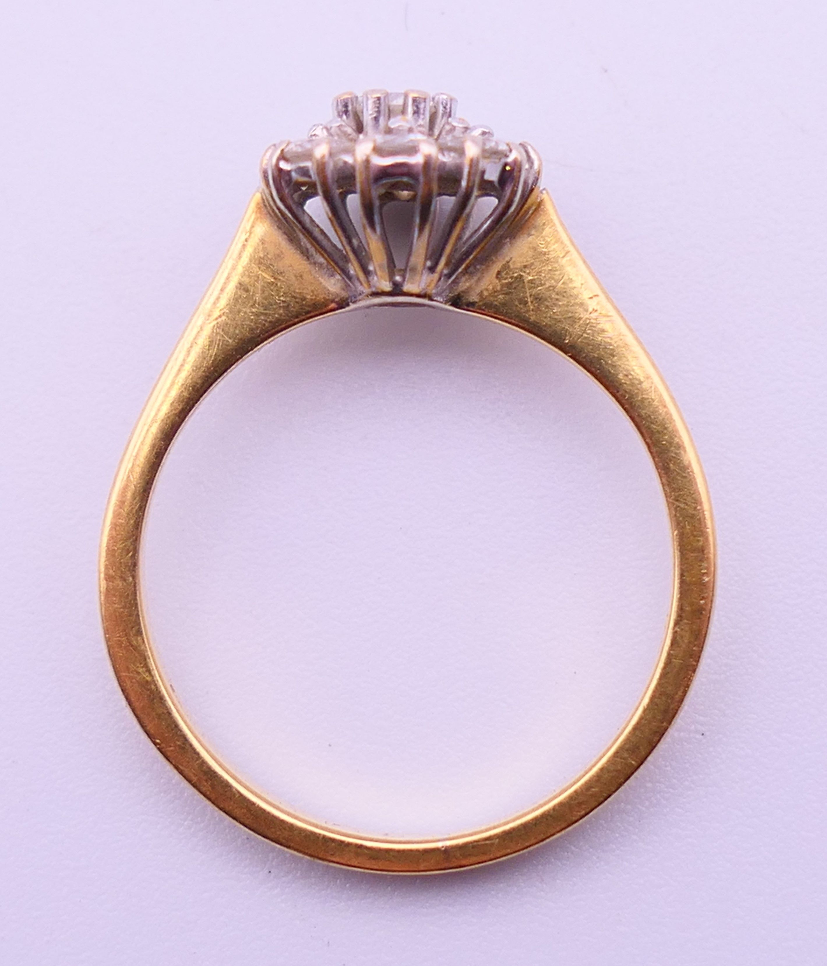 A gold and diamond daisy ring. Ring size M. 3.3 grammes total weight. - Image 6 of 6