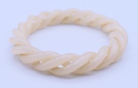 A white jade articulated twist bangle. 5.5 cm diameter.