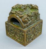 A Chinese bronze dragon seal. 7 cm high.
