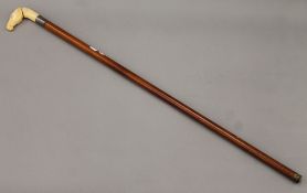 A walking stick with ivorine horse head handle. 87 cm long.