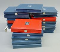Twenty Royal Mint proof coins sets. Each 17 cm wide.