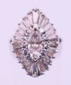 An 18 ct white gold and diamond marquise cluster ring. Ring size K/L.