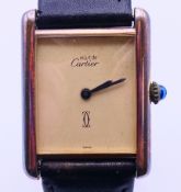 A silver gilt Must de Cartier wristwatch. 2.5 cm wide including crown.