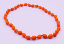 A string of beads. 64 cm long.