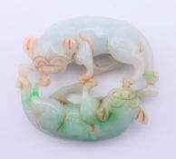 A double dog-of-fo jade roundel. 5.5 cm wide.