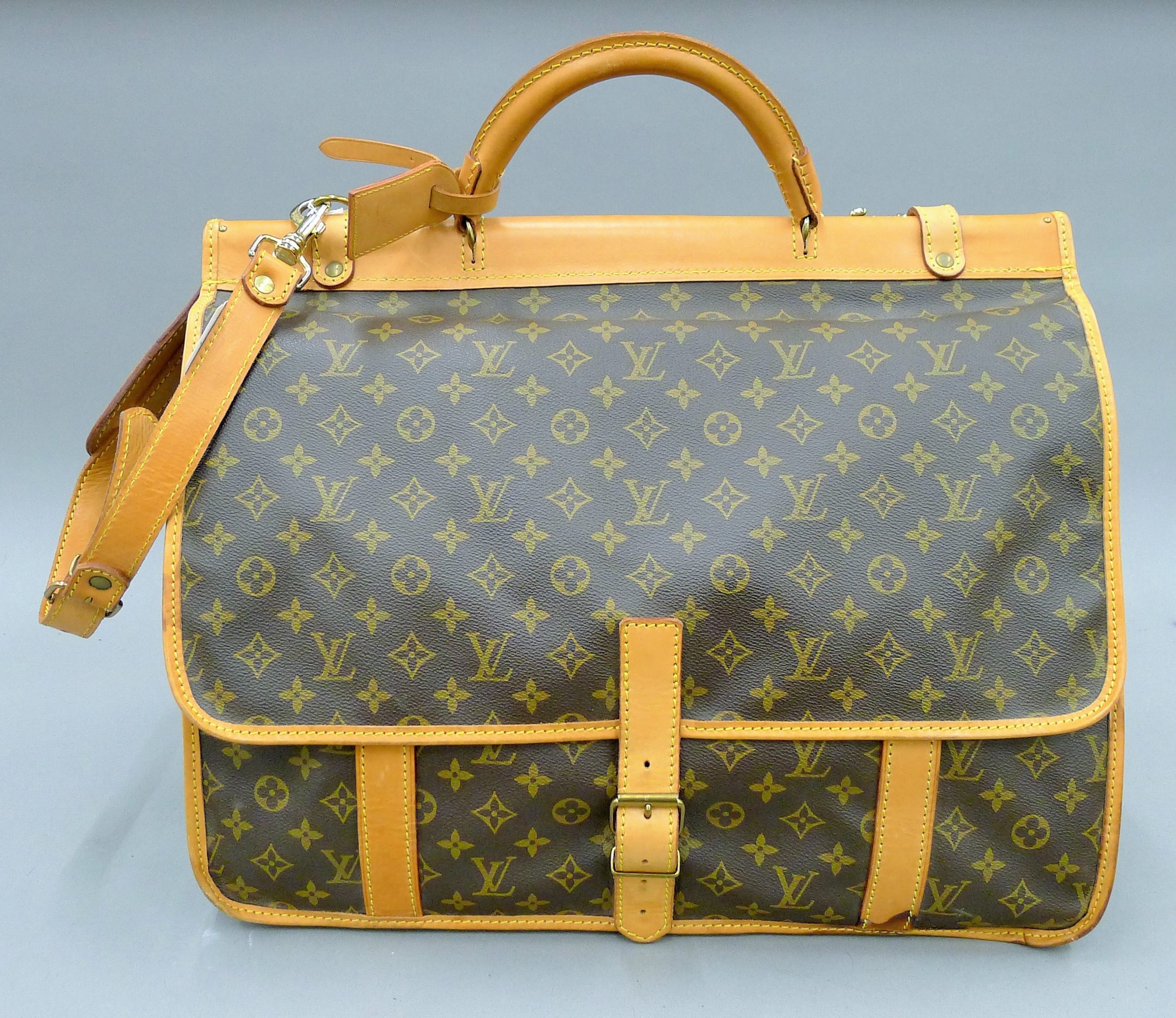 A vintage 1980's Louis Vuitton three-pocket travel bag with leather trim and shoulder strap. - Image 7 of 16