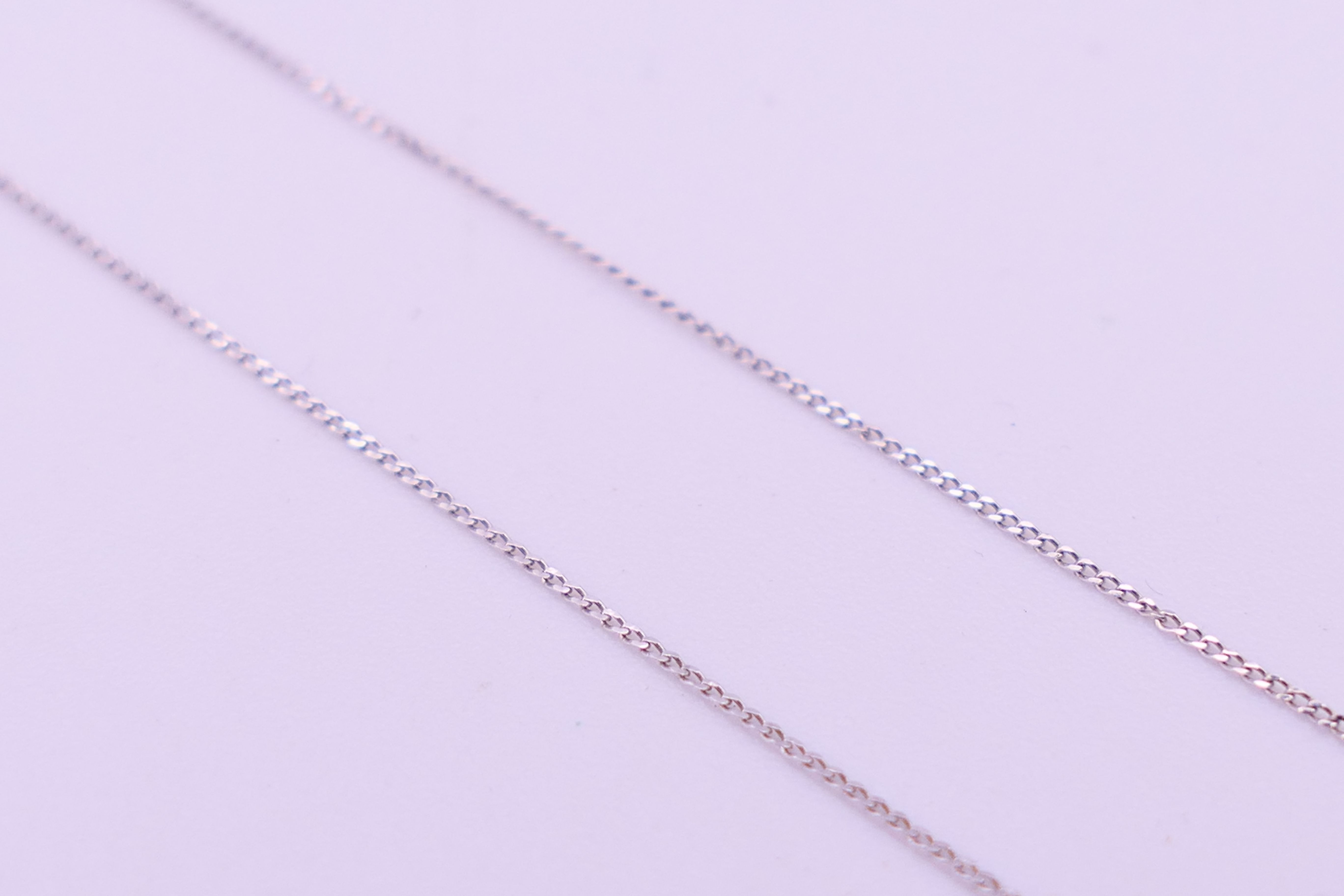 A 9 ct white gold and diamond double heat pendant on a 9 ct white gold chain. Pendant 1. - Image 6 of 8