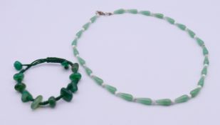 A jade-set necklace and an agate-set bracelet. The former 50 cm long.