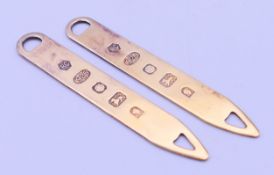 A cased pair of silver collar stiffeners. Each 6.5 cm high.