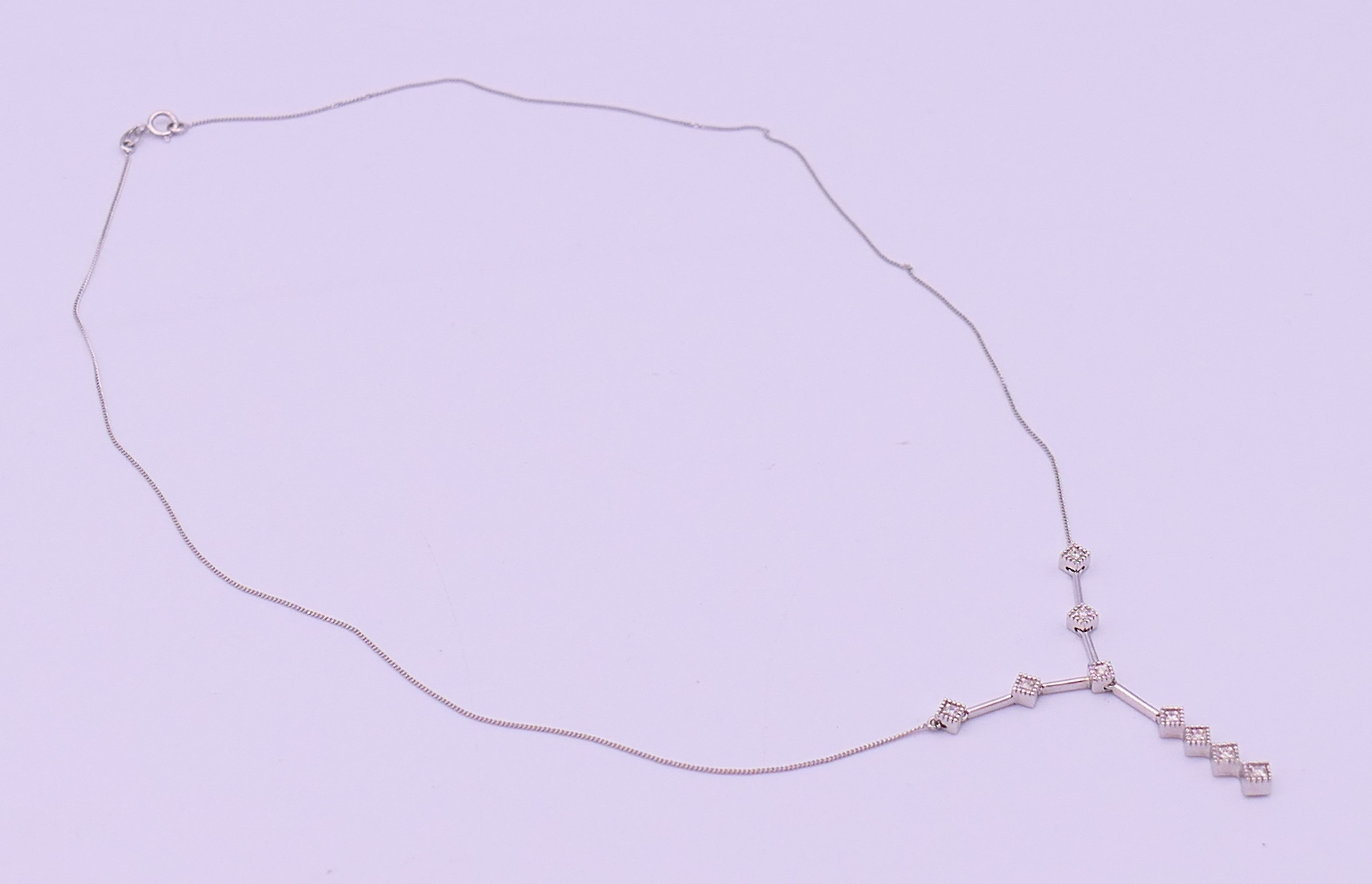 A 9 ct white gold and diamond pendant necklace. Pendant drop 3 cm high, chain 45 cm long. 3. - Image 4 of 8