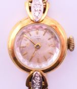 A Girard-Perregoux 14 ct gold ladies' wristwatch on a 14 ct gold strap. 1.7 cm diameter overall.