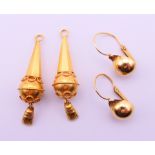 Two pairs of unmarked gold earrings. 3.5 cm high and 1 cm diameter respectively. 4.9 grammes.