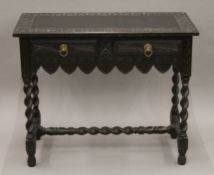 A Victorian carved oak two-drawer side table. 91 cm wide.
