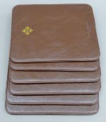 Six Patek Philippe place mats. 23.5 x 19.5 cm.