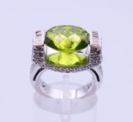 An 18 ct white gold and peridot ring,