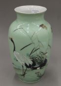 A Japanese porcelain vase decorated with cranes. 31 cm high.