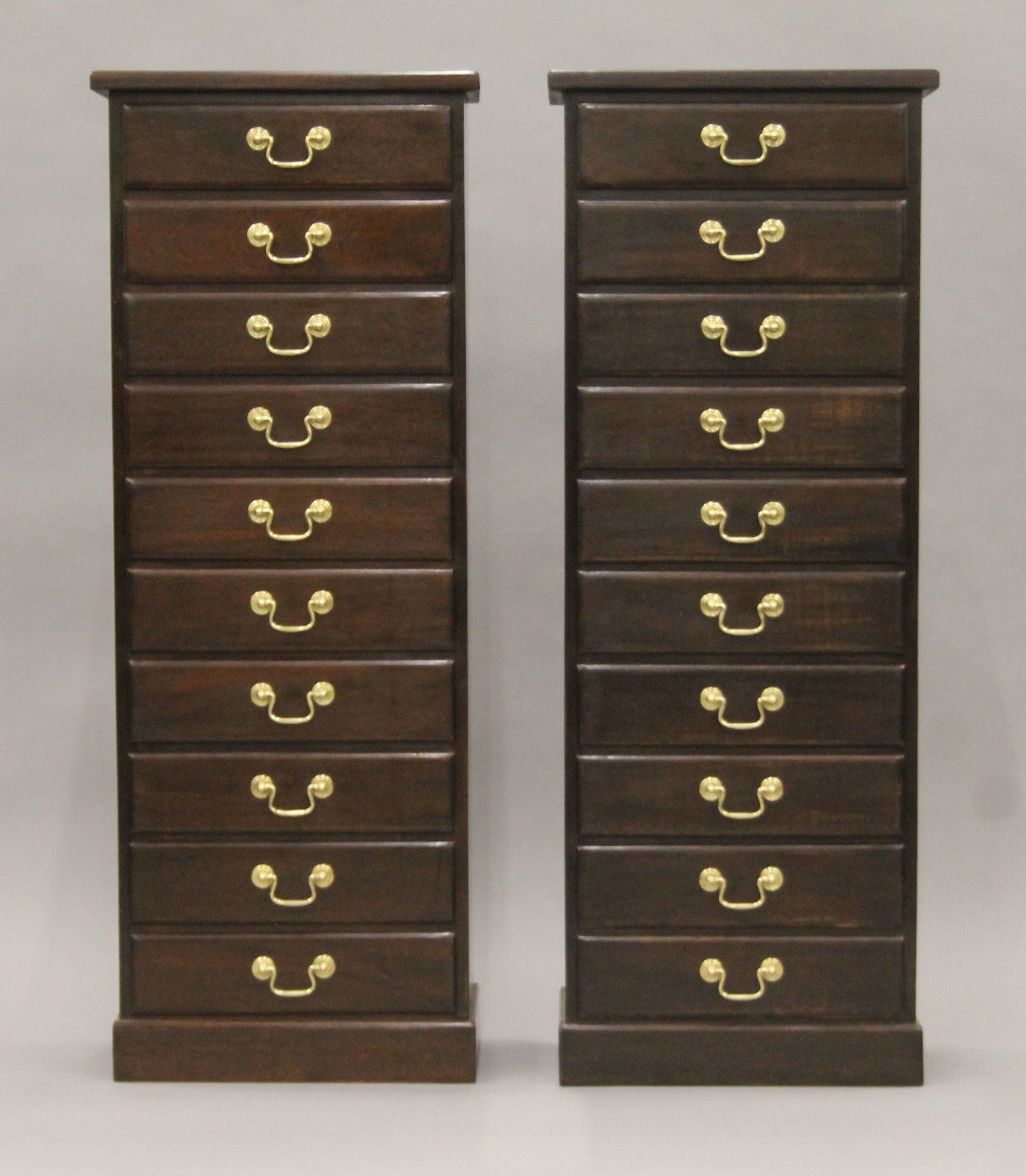 A pair of mahogany flights of drawers. Each 44 cm wide x 117 cm high.