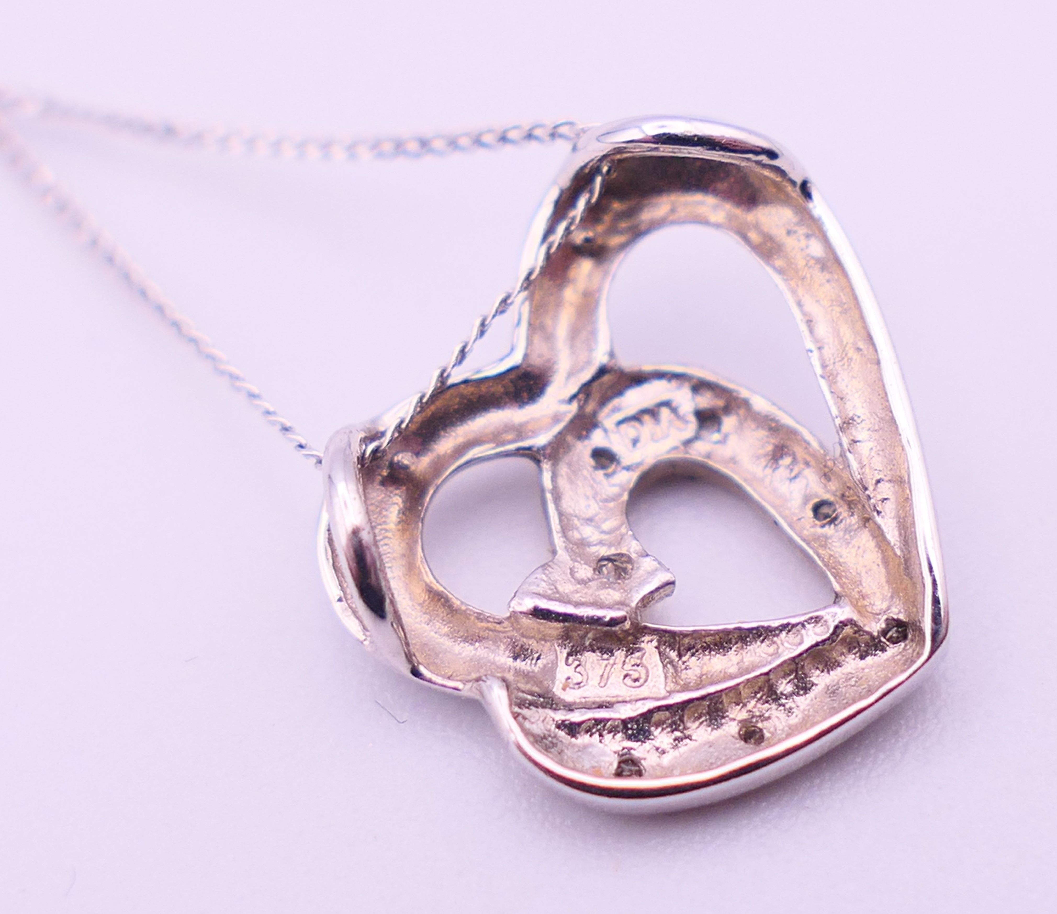 A 9 ct white gold and diamond double heat pendant on a 9 ct white gold chain. Pendant 1. - Image 7 of 8