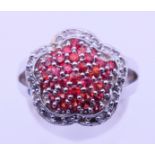 A 14 K white gold cluster ring. Ring size M. 8.1 grammes total weight.