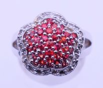 A 14 K white gold cluster ring. Ring size M. 8.1 grammes total weight.