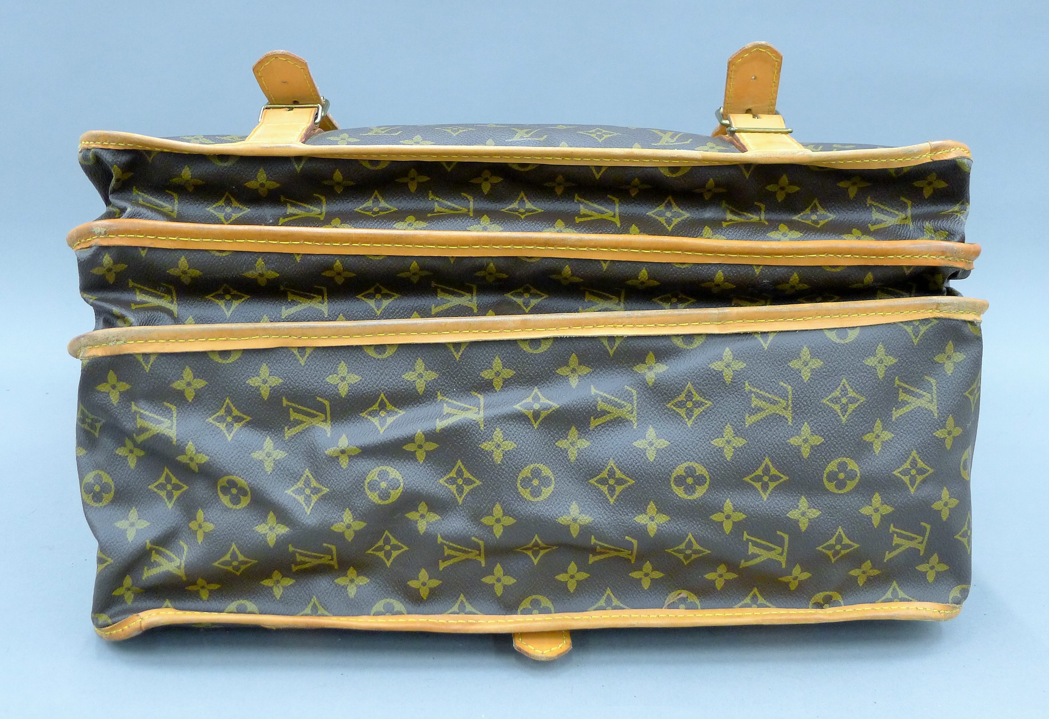 A vintage 1980's Louis Vuitton three-pocket travel bag with leather trim and shoulder strap. - Image 13 of 16