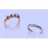 A 9 ct gold three-stone ring and an unmarked half hoop eternity ring. The former, Ring size M and 3.