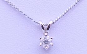 A 9 ct white gold mounted diamond pendant on a 9 ct white gold chain, in a Gucci box.