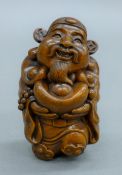 A wooden carving formed as Buddha. 7.5 cm high.
