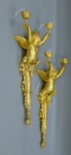 A pair of gilt bronze cherub wall lights. Each 72 cm high.